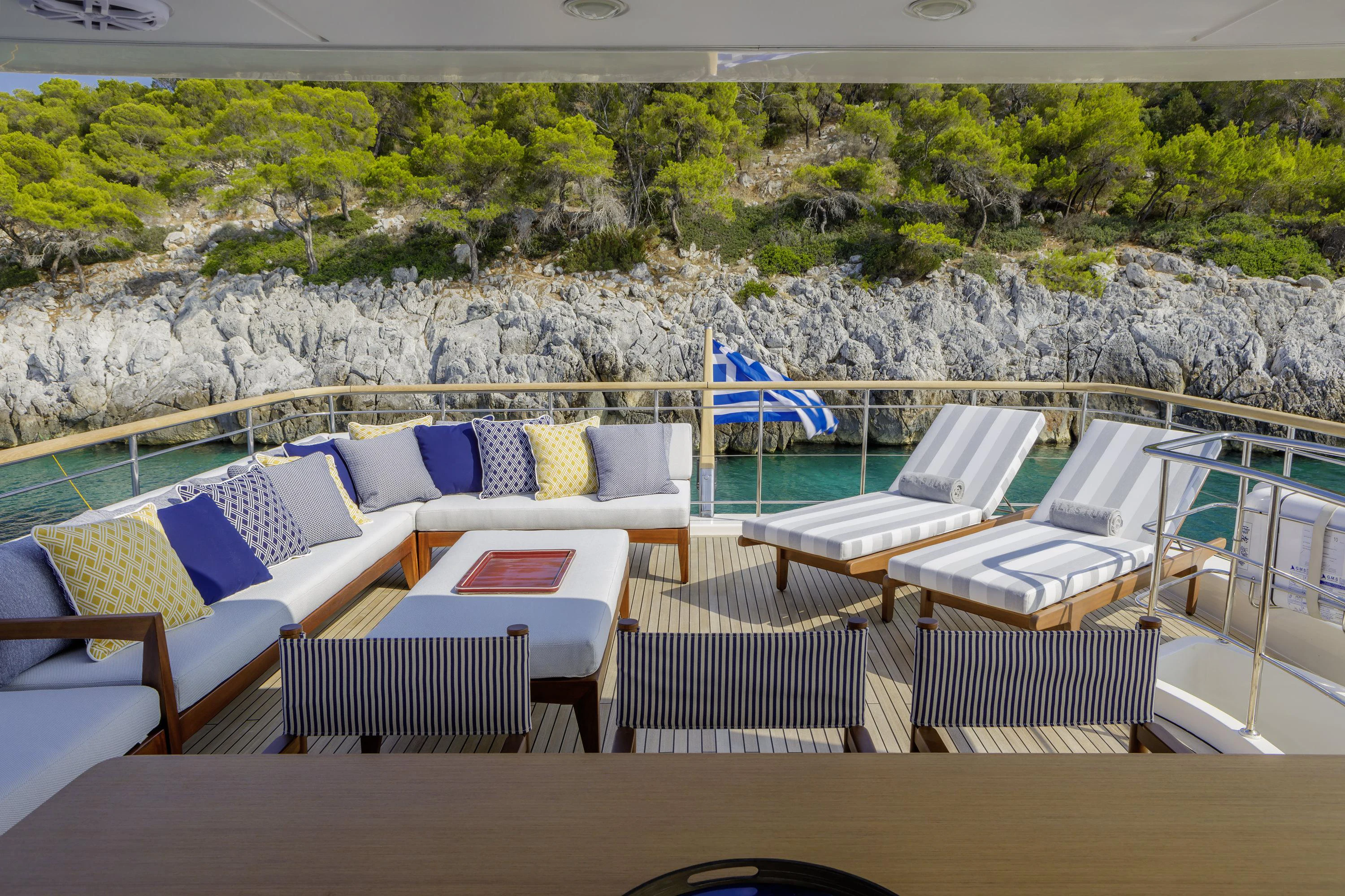a deck with chairs and tables aboard ELYSIUM Yacht for Sale