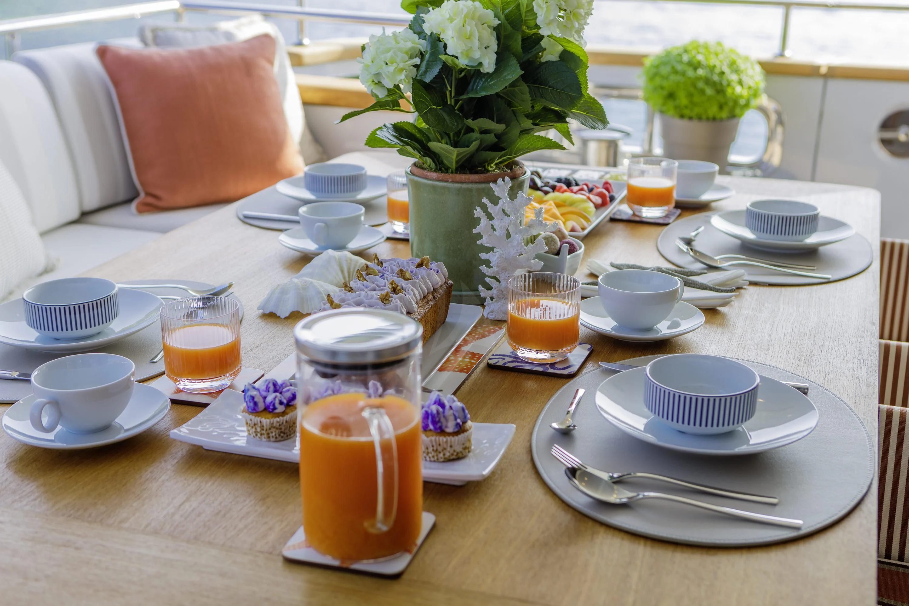 a table with plates and glasses on it aboard ELYSIUM Yacht for Sale