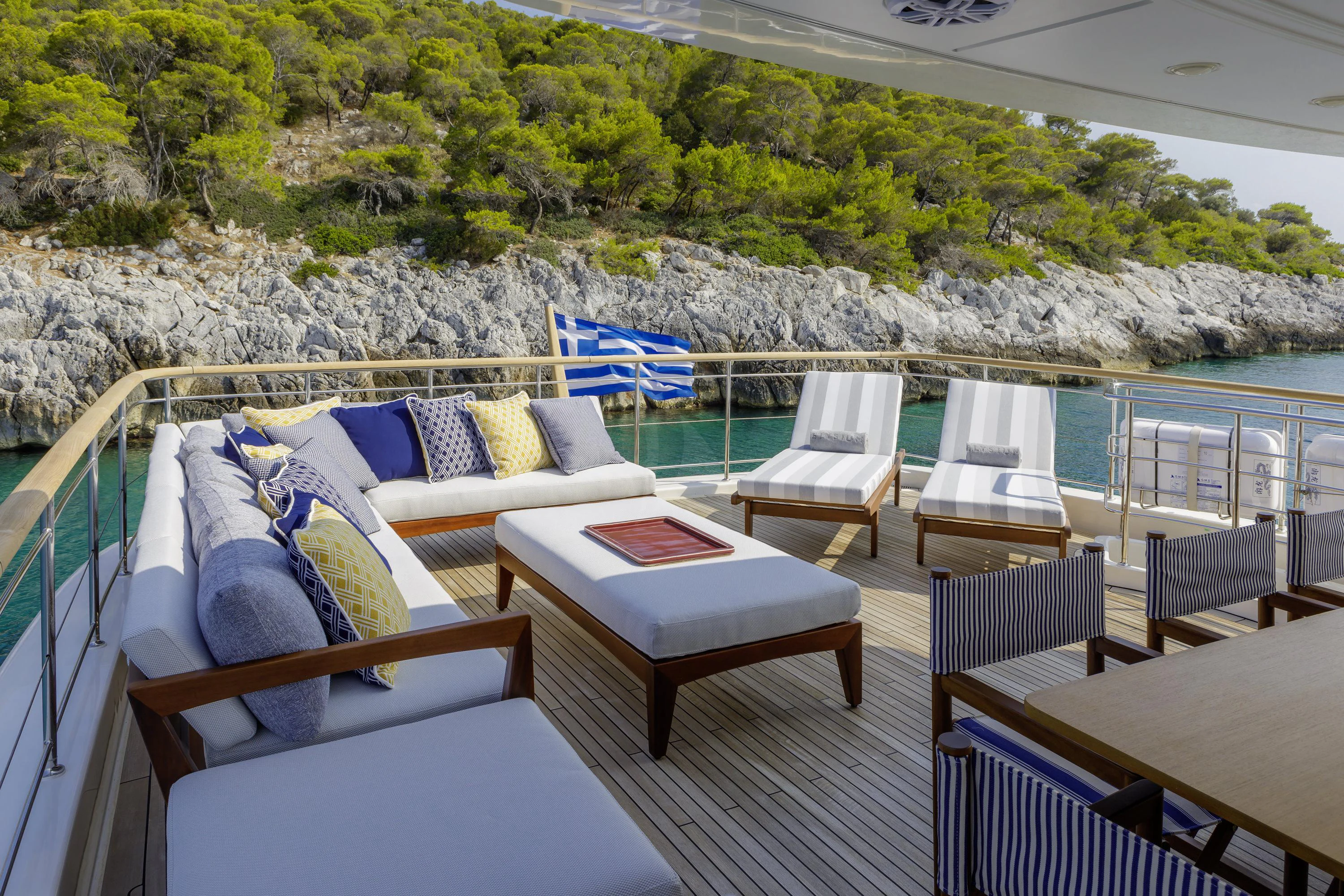 a deck with chairs and a table on it aboard ELYSIUM Yacht for Sale