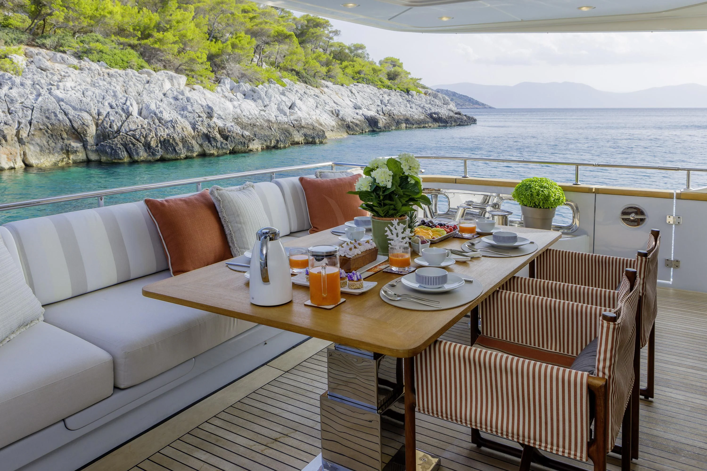 a table with chairs and a couch on it aboard ELYSIUM Yacht for Sale