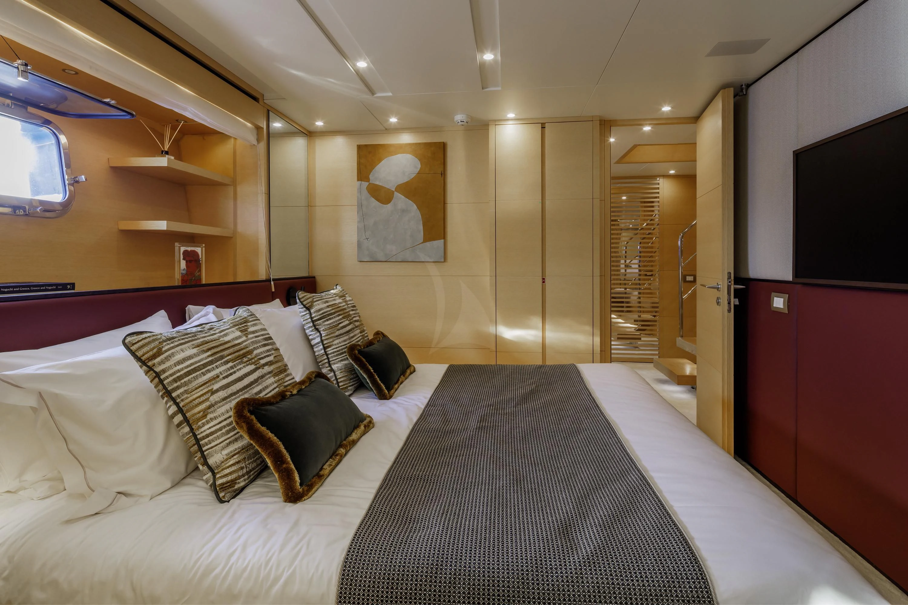 a bed with a black and white checkered bed spread aboard ELYSIUM Yacht for Sale