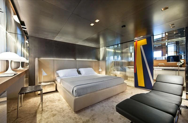 a room with a bed and a chair aboard ELYSIUM Yacht for Sale