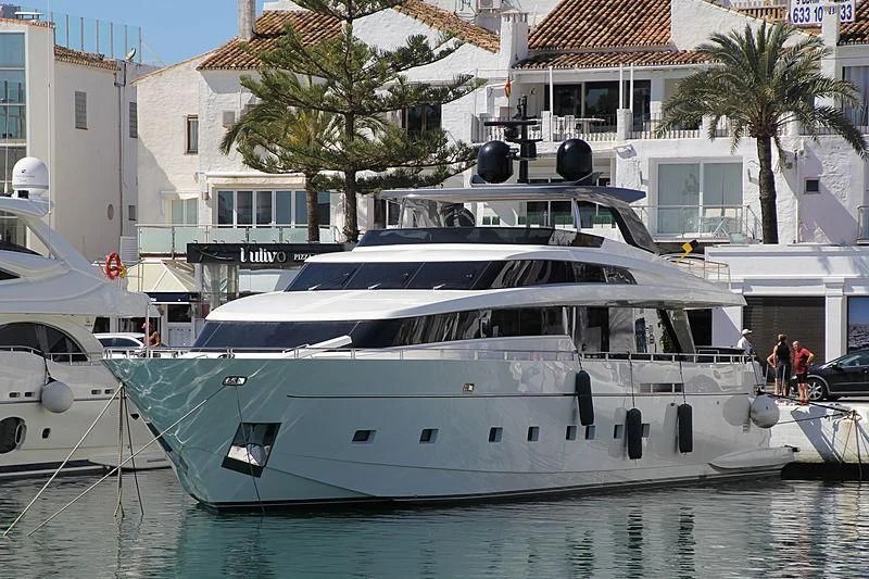a large white yacht in a harbor aboard ELYSIUM Yacht for Sale