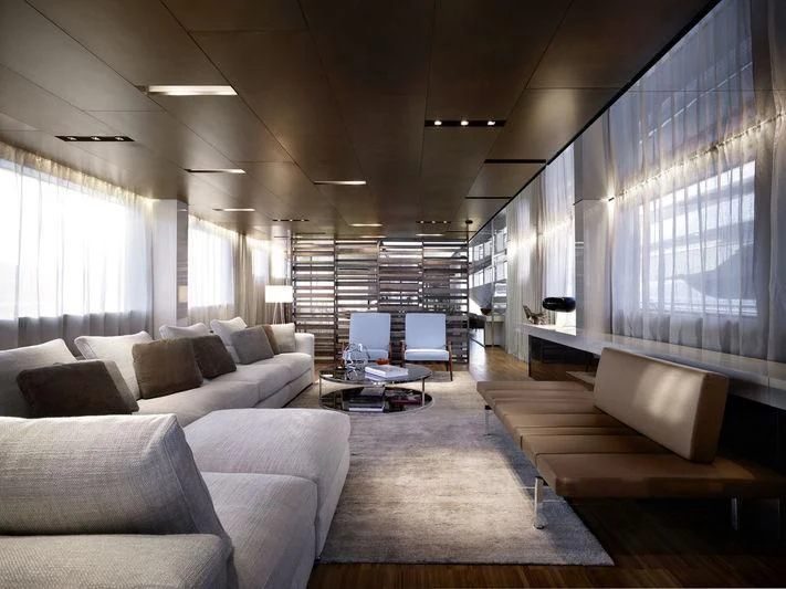 a living room with couches and a laptop aboard ELYSIUM Yacht for Sale