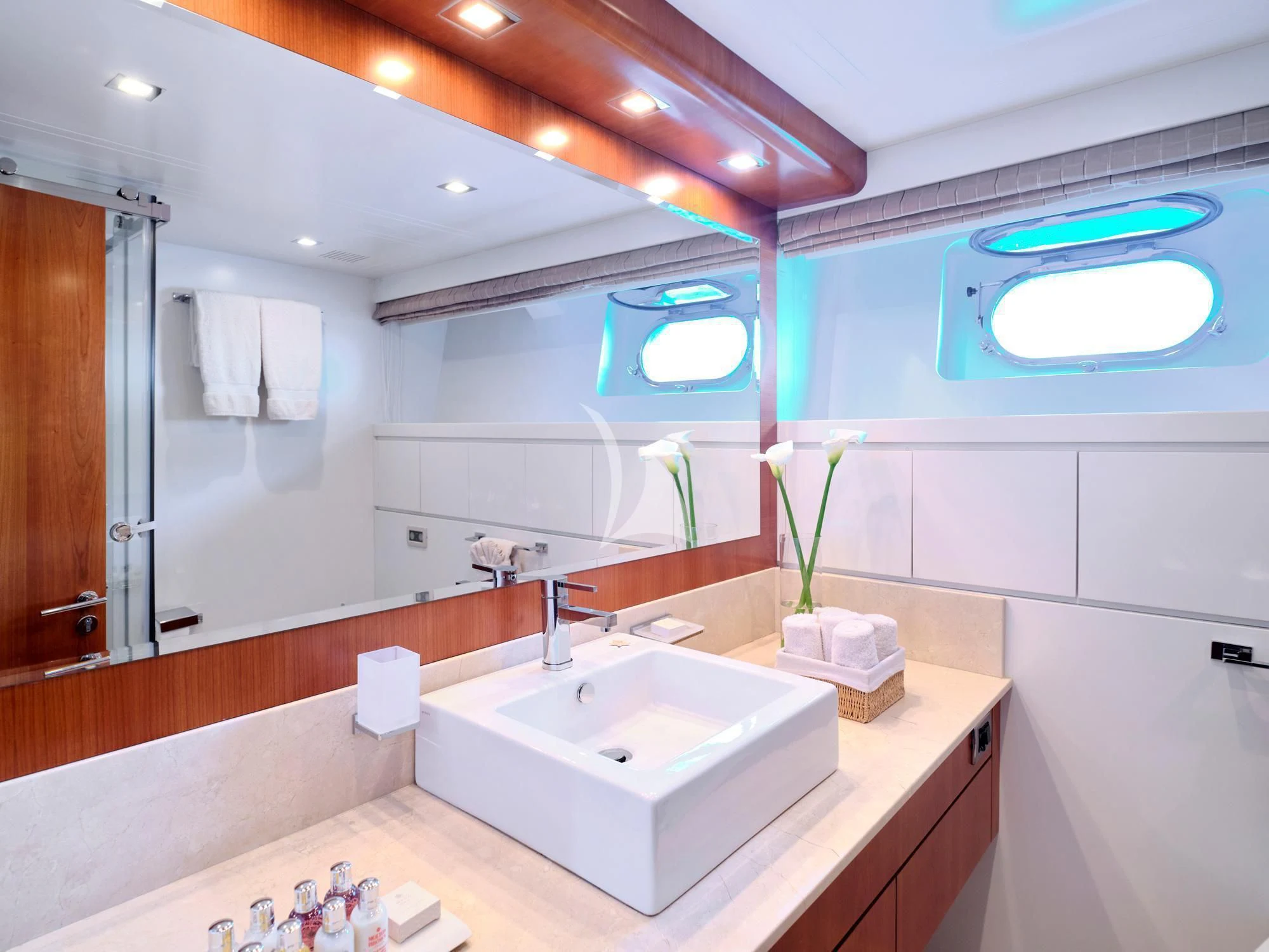 a bathroom with a large mirror aboard HELIOS Yacht for Charter