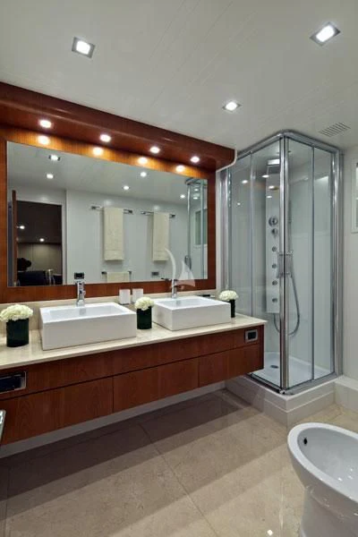 a bathroom with a large mirror aboard HELIOS Yacht for Charter
