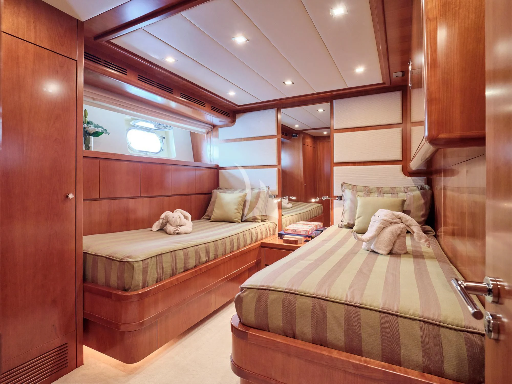 a room with a bed and a mirror aboard HELIOS Yacht for Charter
