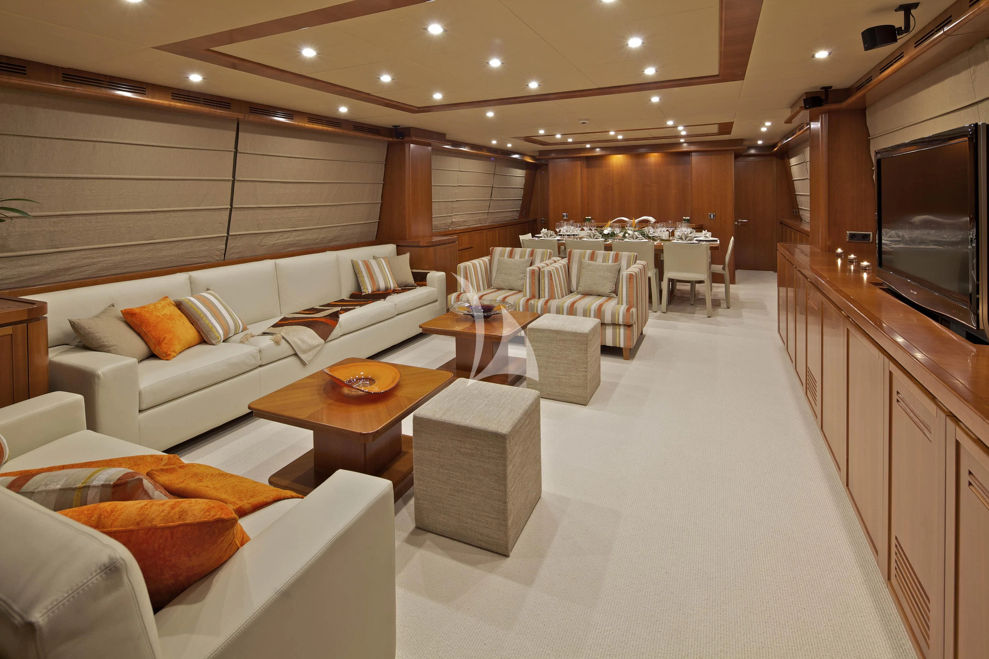 a large living room with a large screen aboard HELIOS Yacht for Charter