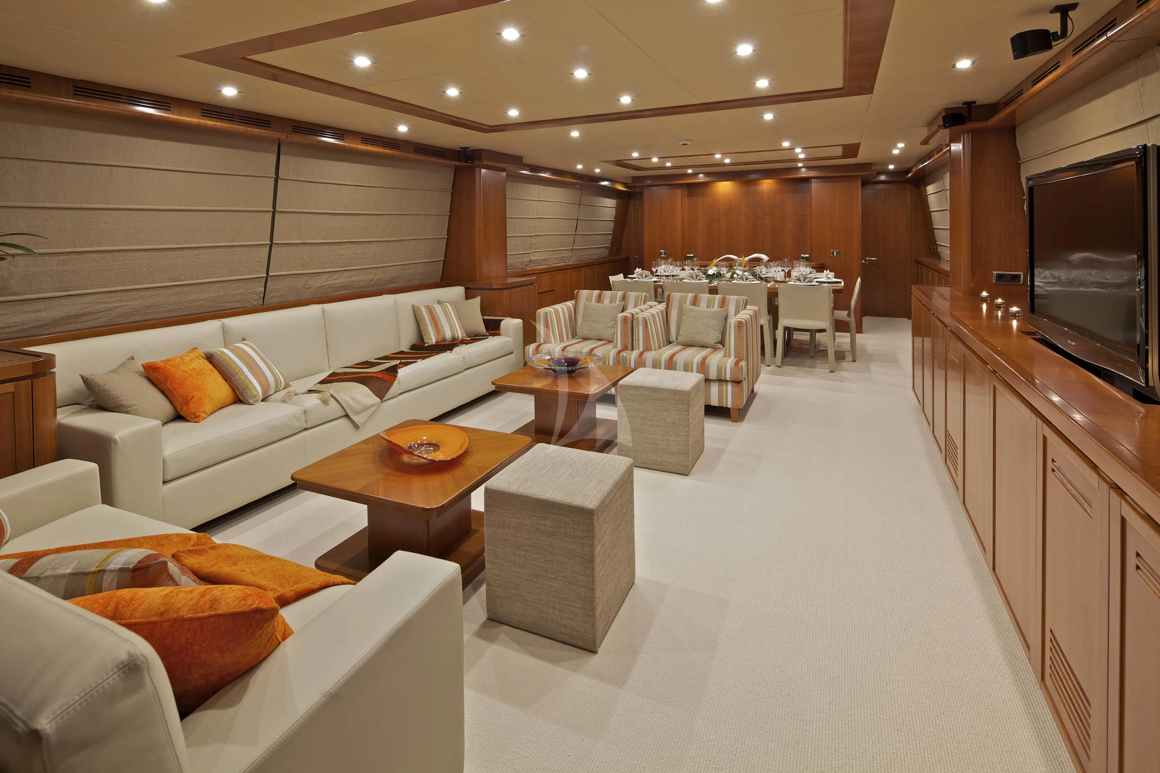 a large living room with a large screen aboard HELIOS Yacht for Charter