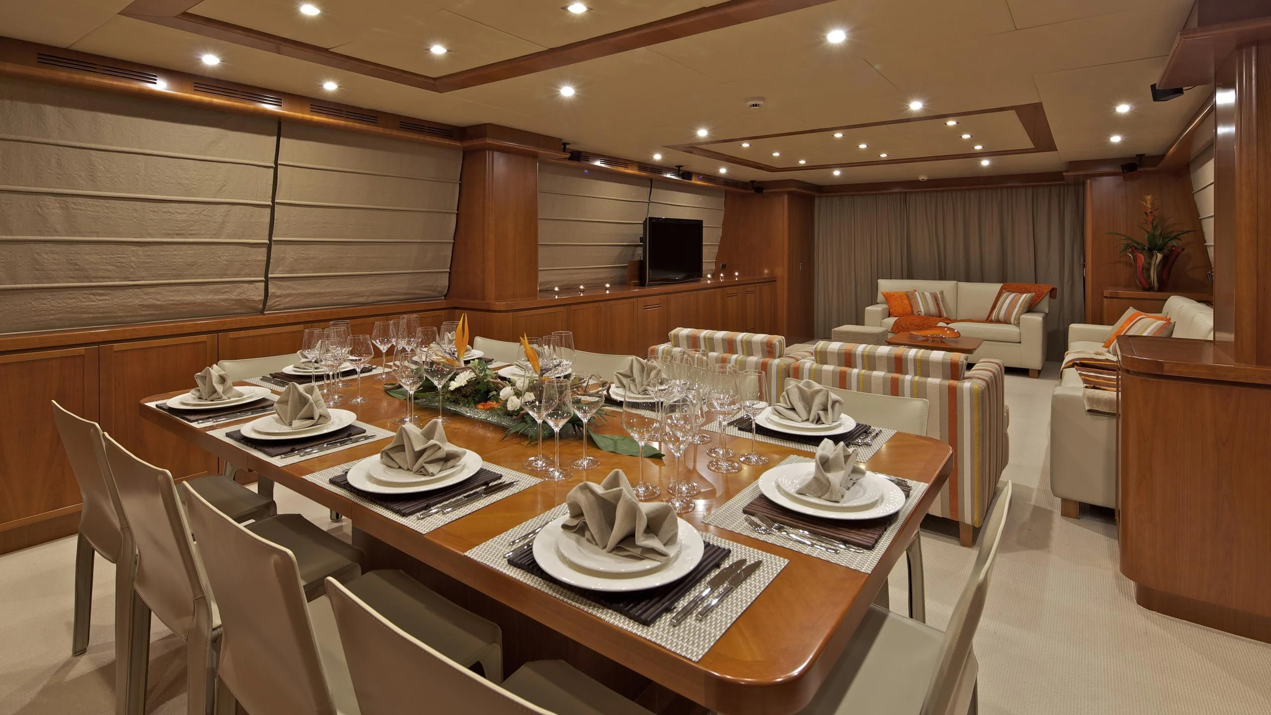 a large dining room with a table set for a dinner aboard HELIOS Yacht for Charter