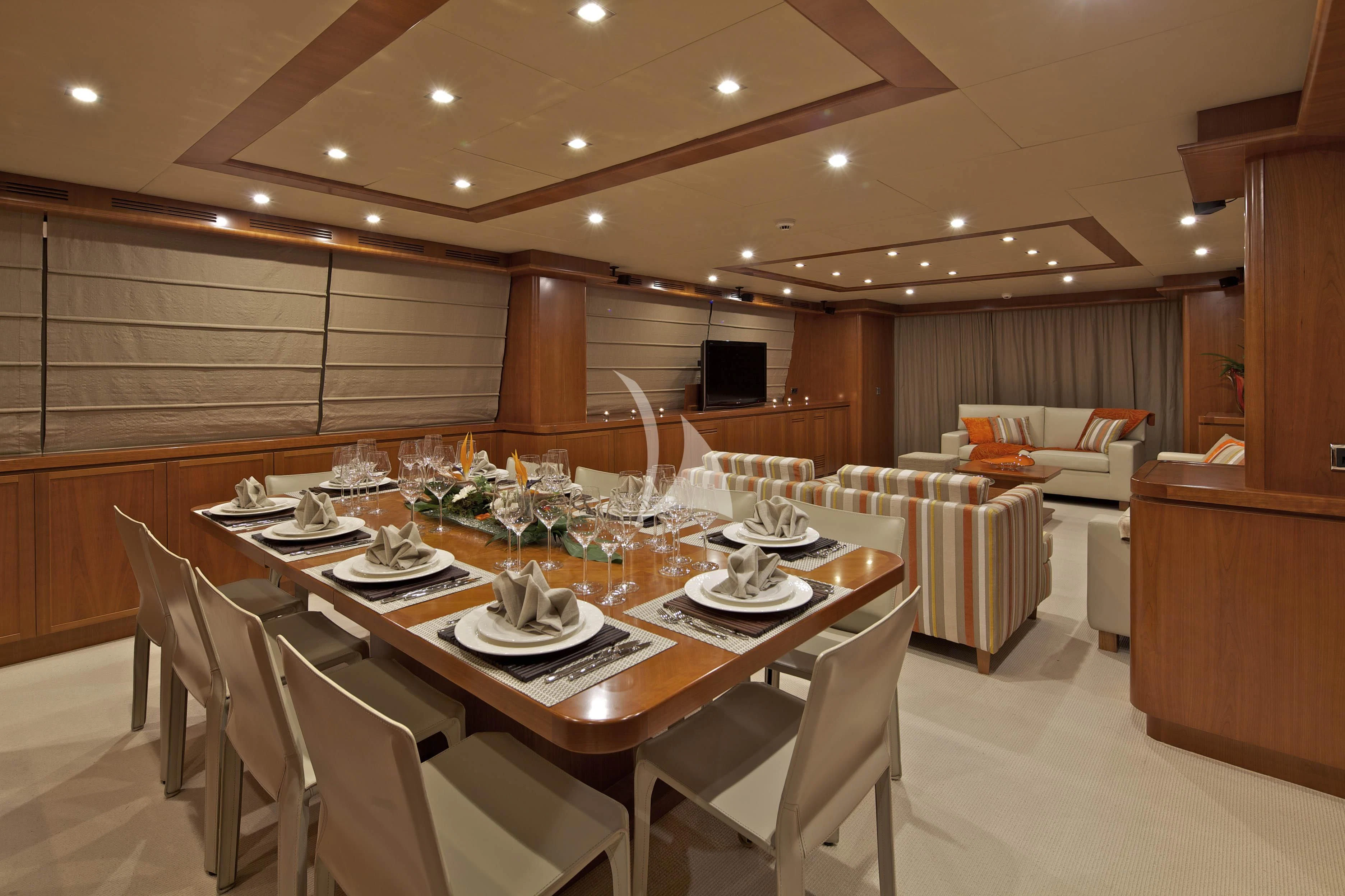 a large room with a table and chairs aboard HELIOS Yacht for Charter