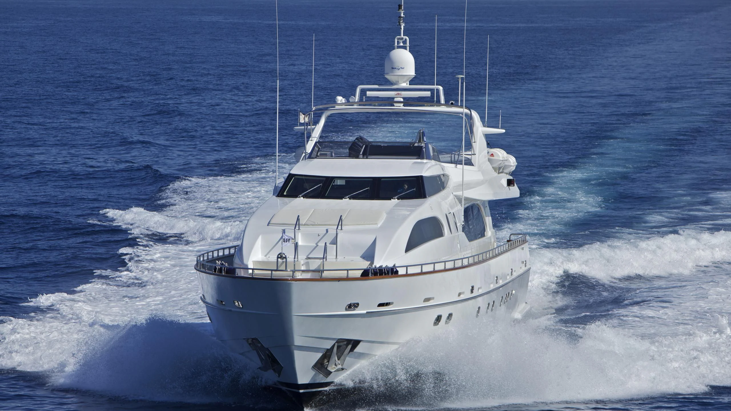 a white boat on the water aboard HELIOS Yacht for Charter