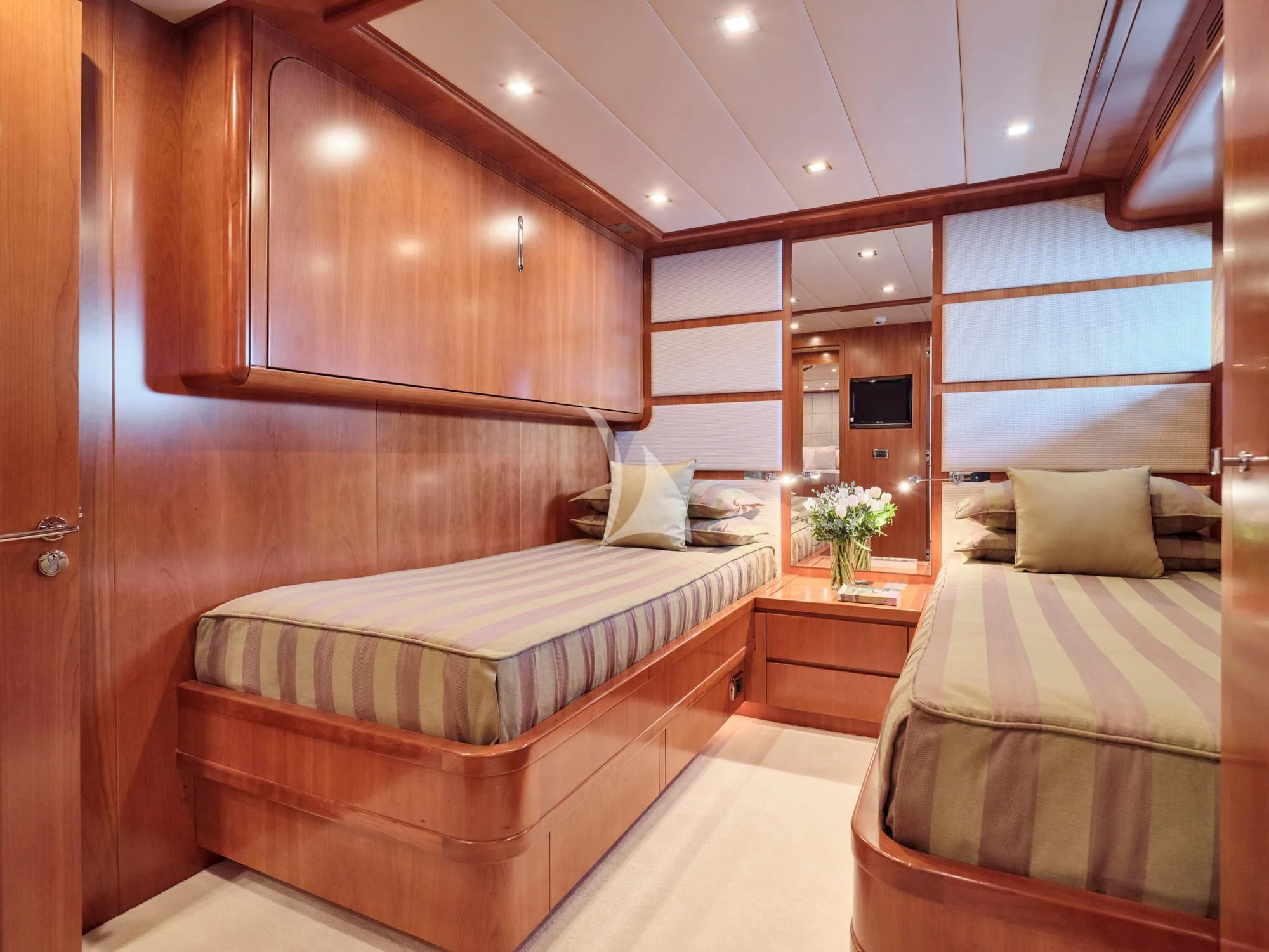 a room with a bed and a mirror aboard HELIOS Yacht for Charter