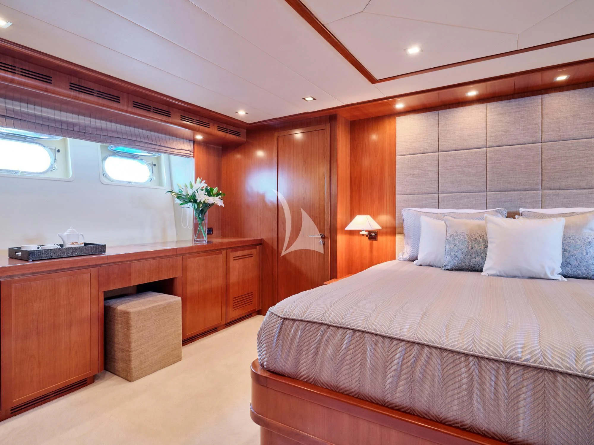 a bedroom with a bed and a desk aboard HELIOS Yacht for Charter