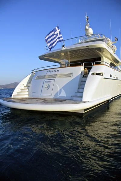 a large white boat on the water aboard HELIOS Yacht for Charter