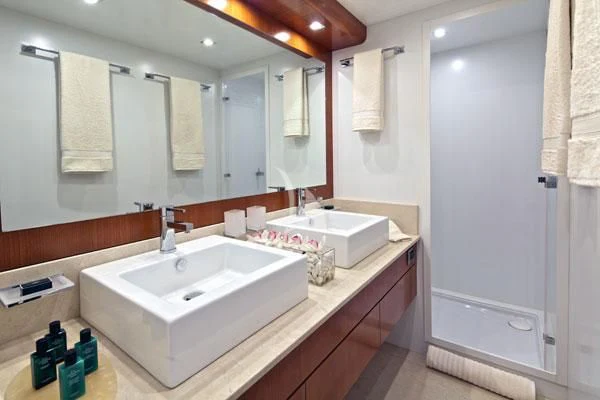 a bathroom with a large mirror aboard HELIOS Yacht for Charter