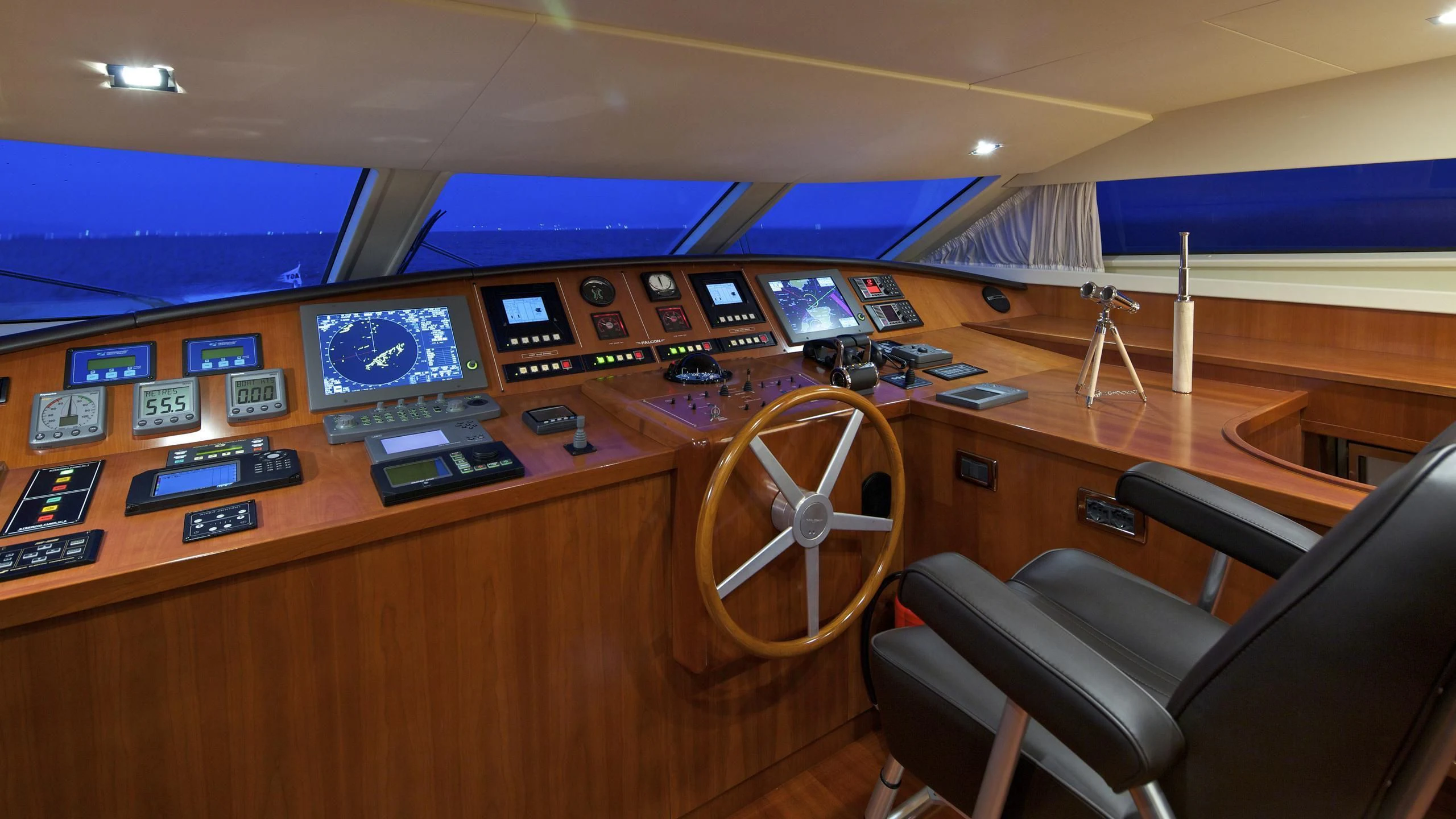 a control room with a large screen aboard HELIOS Yacht for Charter