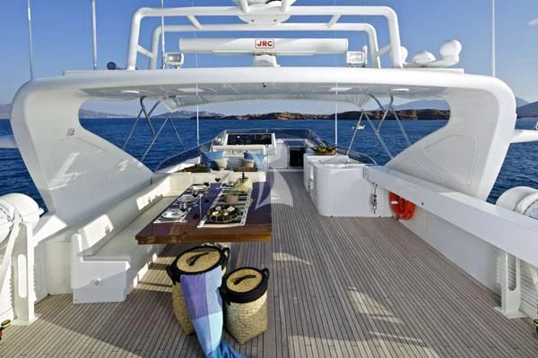a boat docked at a pier aboard HELIOS Yacht for Charter