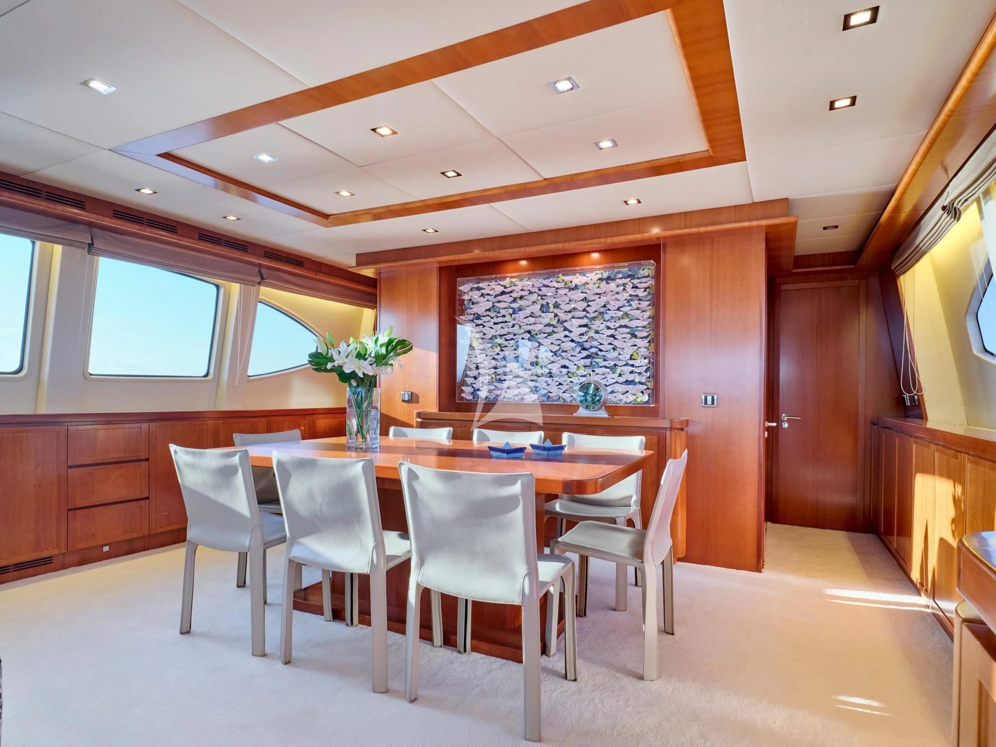 a large dining table in a room aboard HELIOS Yacht for Charter