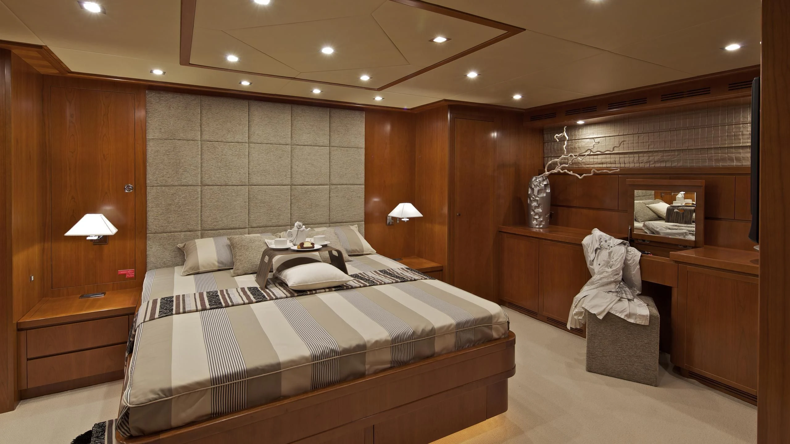 a room with a bed and a mirror aboard HELIOS Yacht for Charter