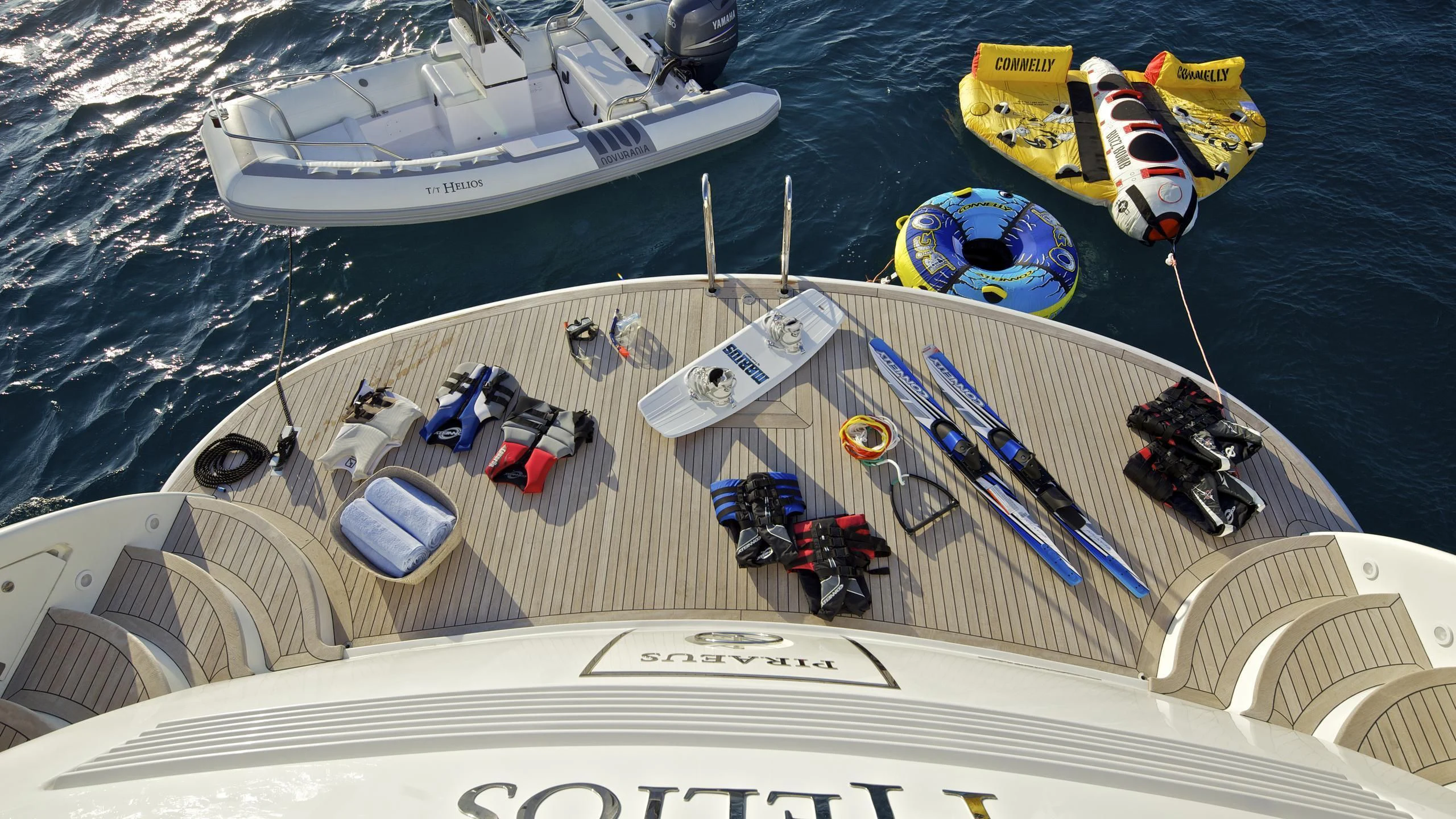 a ship with a group of boats on it aboard HELIOS Yacht for Charter
