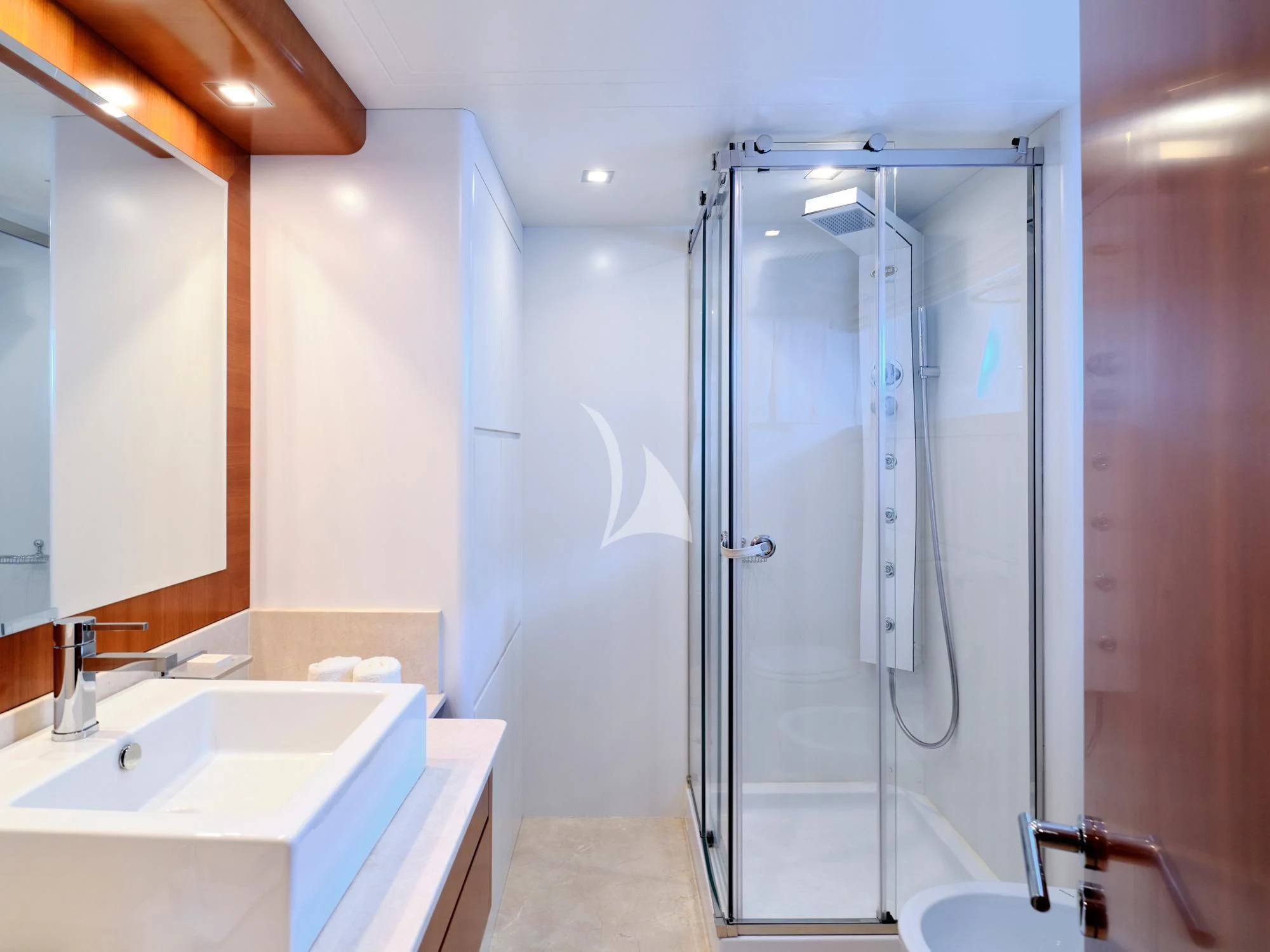 a bathroom with a shower unit and sink aboard HELIOS Yacht for Charter