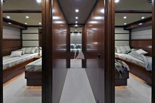 a room with a bed and a mirror aboard HELIOS Yacht for Charter