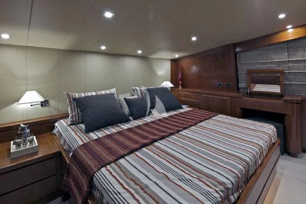 a bed with a colorful comforter aboard HELIOS Yacht for Charter