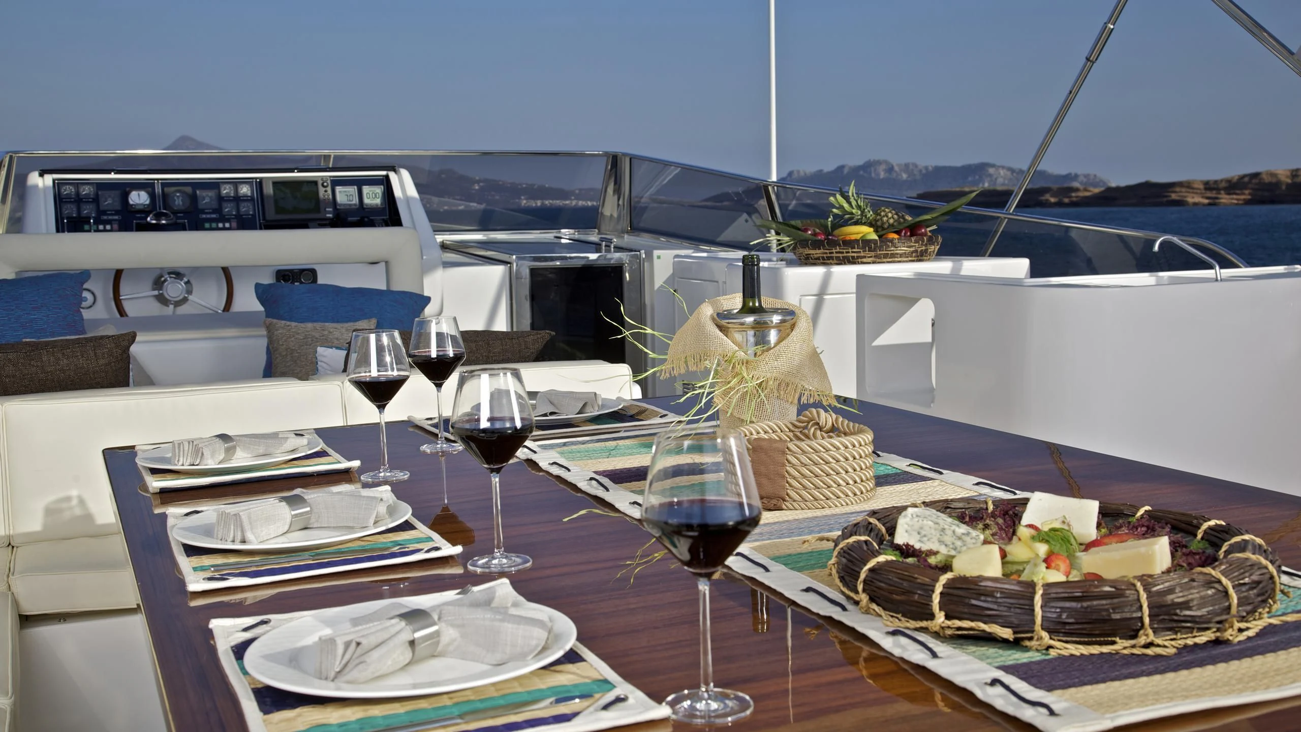 a table with food and wine aboard HELIOS Yacht for Charter