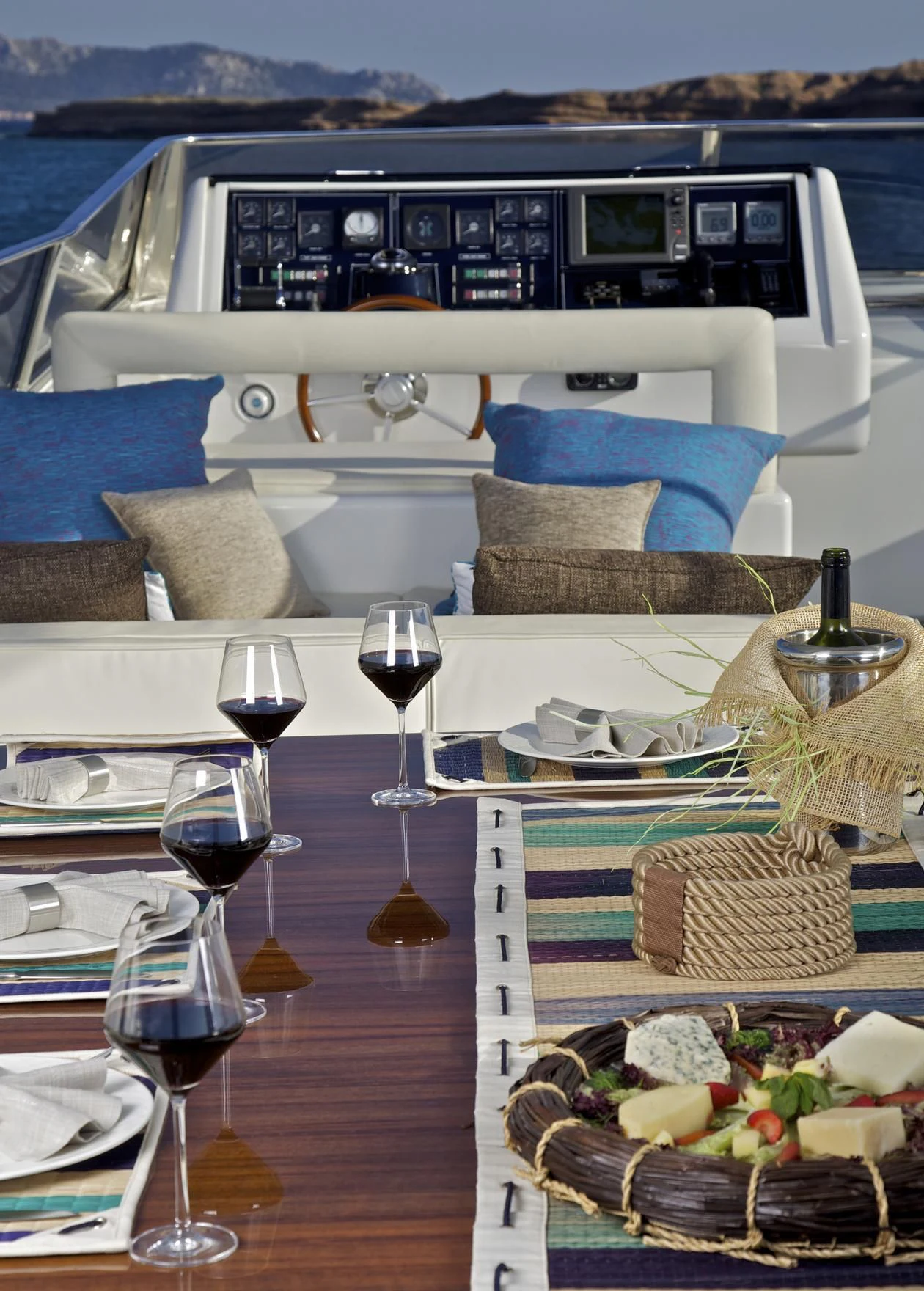 a table with food and wine aboard HELIOS Yacht for Charter