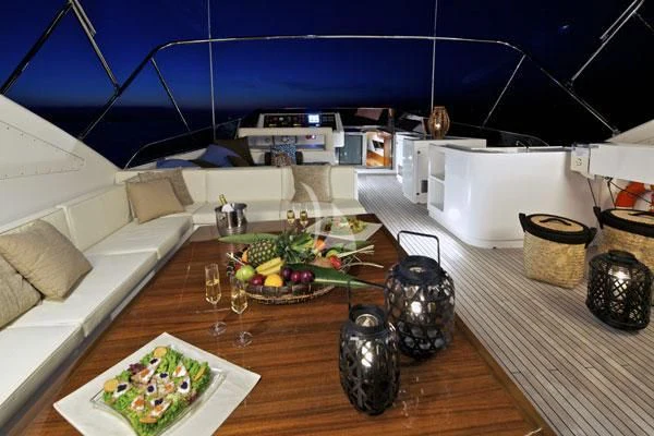 a table with a plate of food and a bowl of fruit on it aboard HELIOS Yacht for Charter