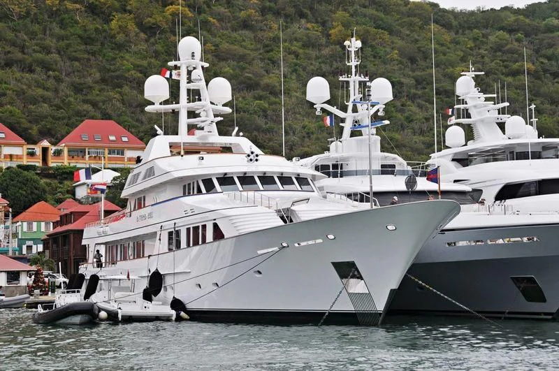 a couple of large white boats in the water aboard MARIA Yacht for Sale