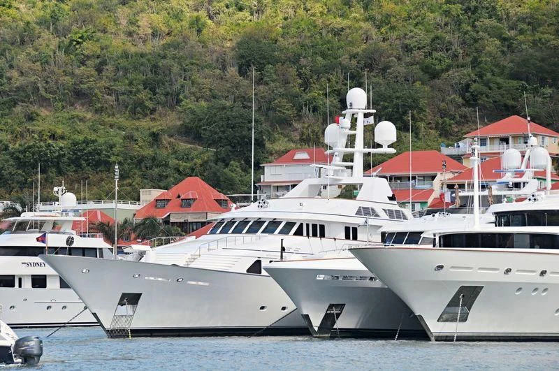 several white yachts in a harbor aboard MARIA Yacht for Sale