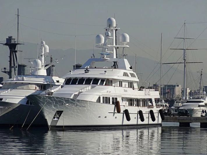 a large white boat in a harbor aboard MARIA Yacht for Sale
