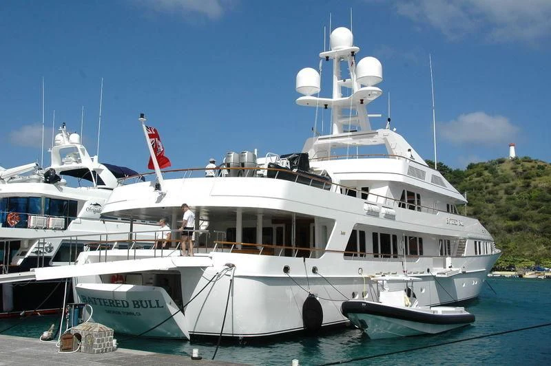 a large white boat with a flag on the front aboard MARIA Yacht for Sale