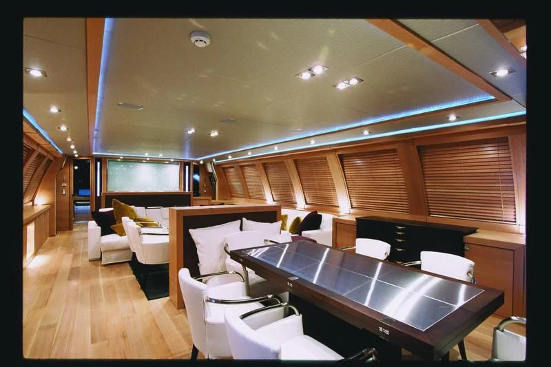 a room with a large counter and chairs aboard ESCAPE Yacht for Sale