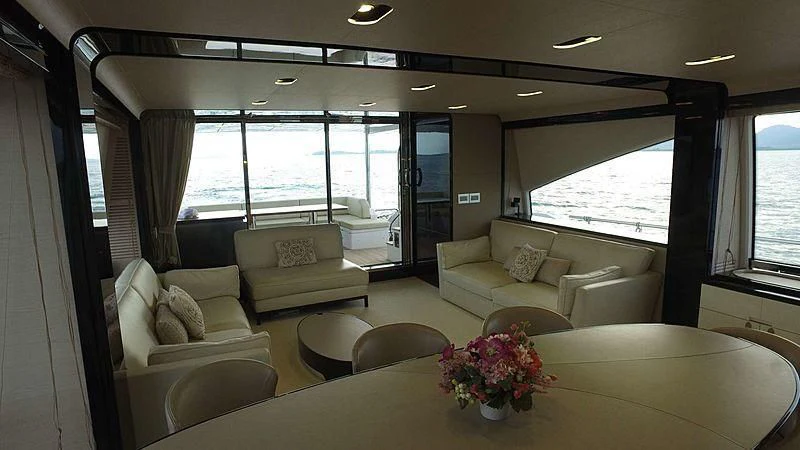 a living room with a table and chairs aboard SOLACE NT Yacht for Sale