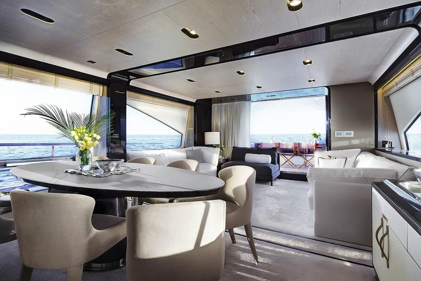 a room with a table chairs and a large window aboard SOLACE NT Yacht for Sale