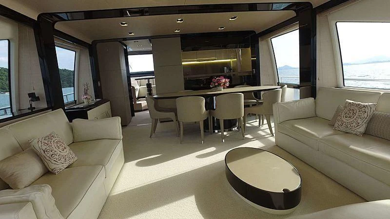 a living room with a table and couches aboard SOLACE NT Yacht for Sale