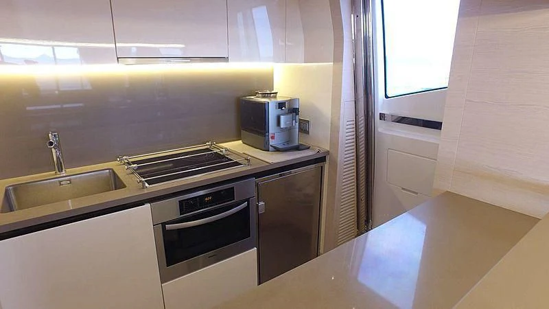 a kitchen with a stove and a microwave aboard SOLACE NT Yacht for Sale
