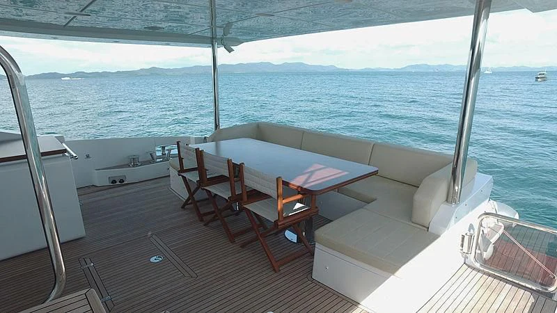 a room with a table and chairs aboard SOLACE NT Yacht for Sale