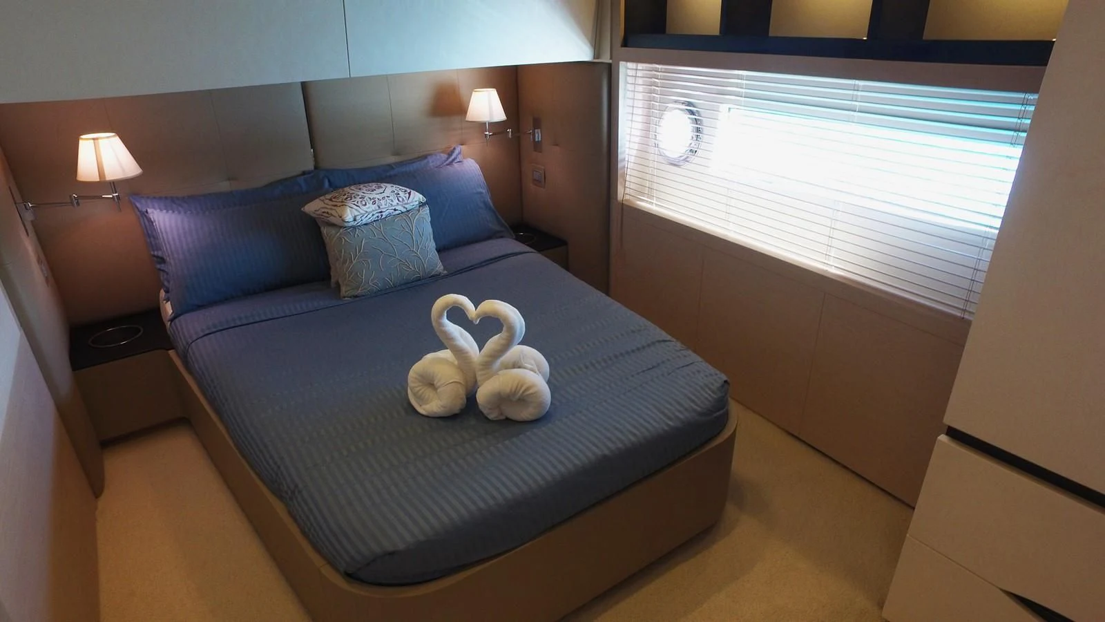 a bed with a blue sheet and a blue bed spread aboard SOLACE NT Yacht for Sale