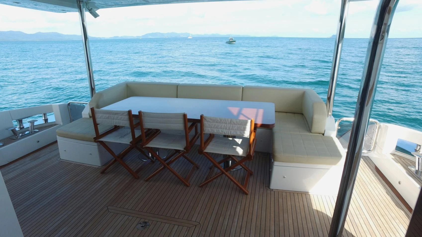 a room with a table and chairs aboard SOLACE NT Yacht for Sale
