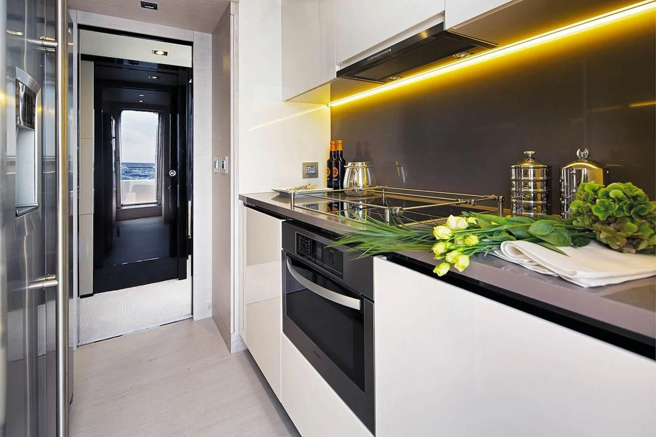 a kitchen with a black stove and white cabinets aboard SOLACE NT Yacht for Sale
