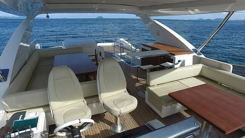 a boat with chairs and a table on it aboard SOLACE NT Yacht for Sale
