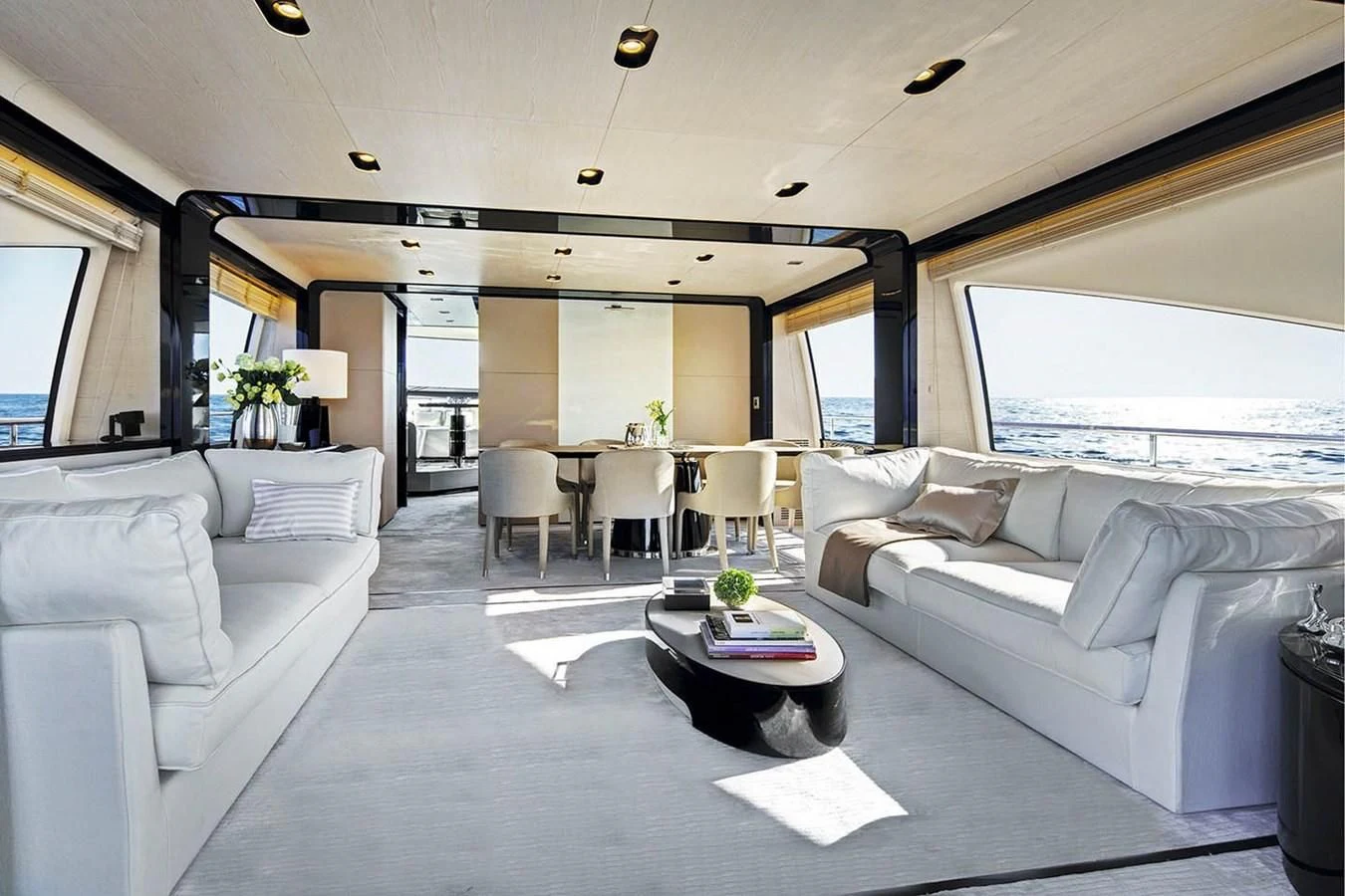 a living room with white couches aboard SOLACE NT Yacht for Sale