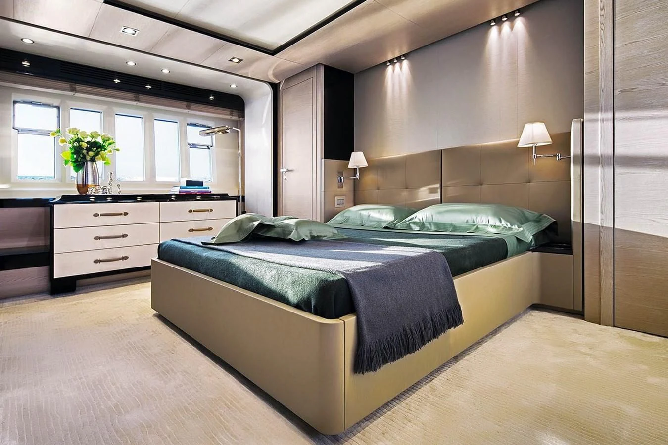 a bedroom with a bed and a desk aboard SOLACE NT Yacht for Sale
