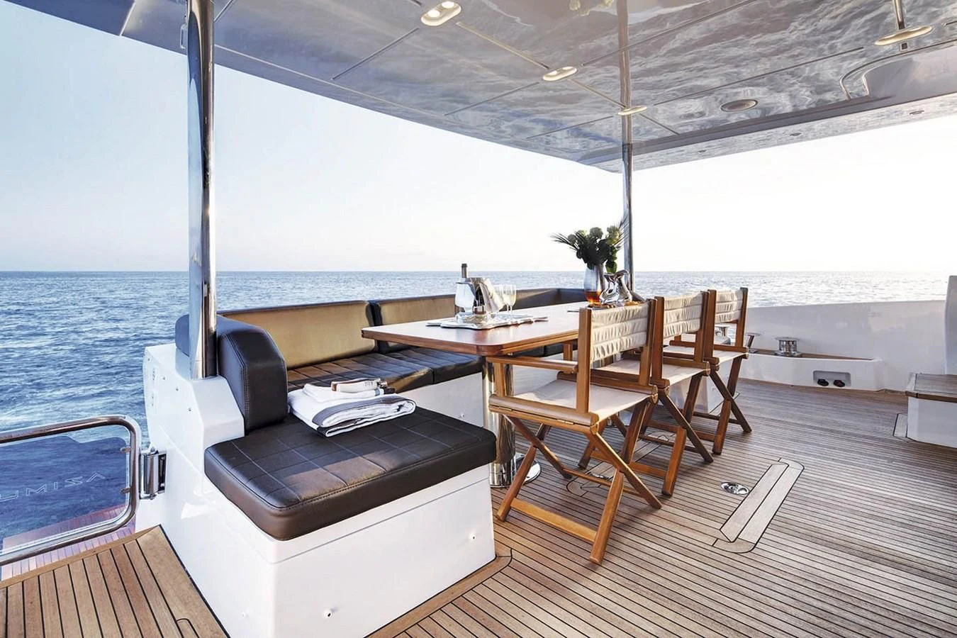 a boat with a table and chairs aboard SOLACE NT Yacht for Sale