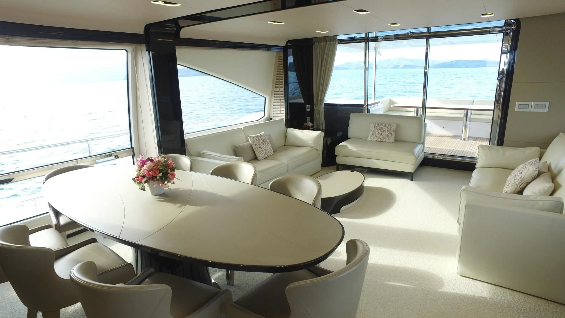 a room with a table chairs and a large window aboard SOLACE NT Yacht for Sale