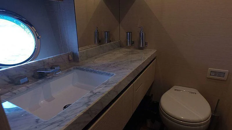 a bathroom with a tub sink and a toilet aboard SOLACE NT Yacht for Sale